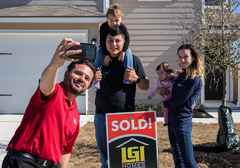 Family Taking Photo with LGI Homes Sales Rep